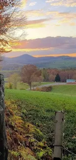 Scenic countryside sunset with lush green fields and vibrant autumn colors.