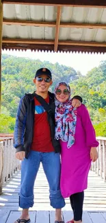 Couple posing on a scenic wooden bridge in nature.