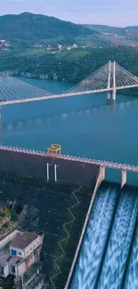 Scenic dam with bridge and lush green landscape.