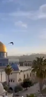 Dome of the Rock with birds flying in a serene blue sky.