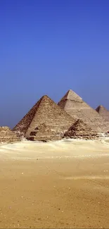 Majestic Egyptian pyramids under a clear blue sky in the desert.