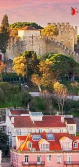 Scenic European cityscape with fortress and colorful houses at sunset.