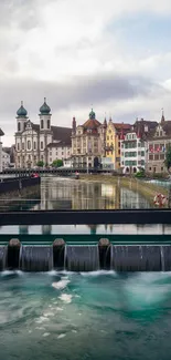 Scenic European cityscape with river and historic architecture.