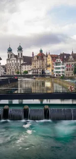 Scenic view of a European riverside with historic buildings and flowing water.