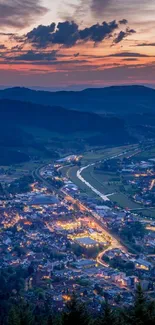 Evening cityscape with glowing lights and a colorful sunset over hills.