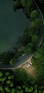 Aerial view of forest road by a lake.