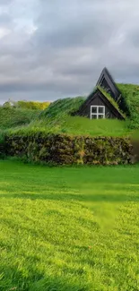 Mobile wallpaper featuring a scenic house with a grass roof in a lush, green landscape.