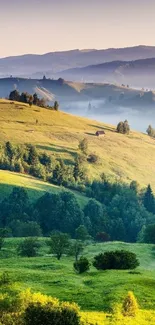 A breathtaking view of green hills with misty valleys and distant mountains.