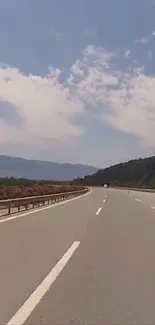 Scenic highway with blue skies and clouds, perfect for travel lovers.