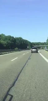 Scenic highway with lush greenery and clear blue sky on a serene drive.