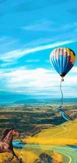 A vibrant hot air balloon over a winding road and countryside.