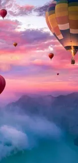 Colorful hot air balloons over mountains at sunset.