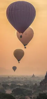 Hot air balloons drift across a scenic sunset.