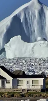 Stunning iceberg view behind a house in a serene landscape.