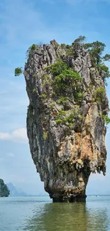 Scenic island rock formation in blue waters and clear sky.