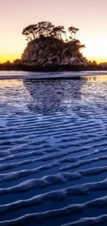 Scenic island and sunset with purple and orange hues reflected on the water.