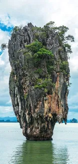 Scenic island view with towering rocks over the emerald ocean.