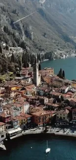 Aerial view of an Italian village by a tranquil lake with colorful houses.