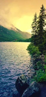 A serene forest path beside a mountain lake during sunset perfect for mobile wallpaper.