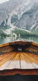 Tranquil lake with mountain view and wooden boat.