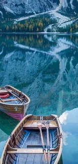 Wooden boats on a serene mountain lake with reflections and a blue hue.