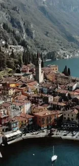 Aerial view of a colorful village by Lake Como with mountains in the background.