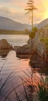 Peaceful sunset over mountain lake with reflective water and lush surroundings.