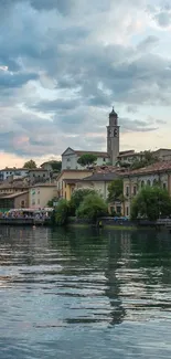 Picturesque lakeside village with mountain view at dusk.