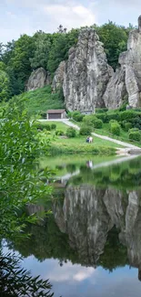 Lakeside rock formation with serene reflection and greenery.