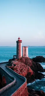 Lighthouse stands by the blue ocean under a clear sky, offering a serene scenery.