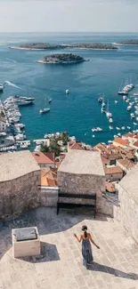 Aerial view of Mediterranean harbor with boats and buildings.