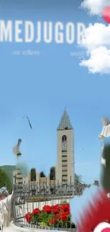 Scenic view of Medjugorje church under blue sky with vibrant flowers.