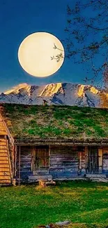 Moonlit cottage with a scenic mountain backdrop under a dark blue night sky.