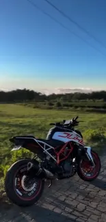 Motorcycle on a scenic road amid lush greenery and clear blue sky.