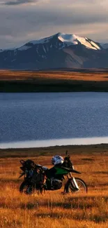 Motorcycle in front of mountain and lake at sunset