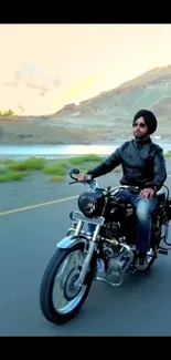 Motorcyclist riding through scenic landscape, blue hues dominate.