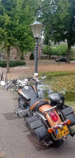 A motorcycle parked on a scenic path in a lush green park setting.