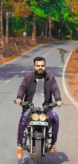 Man riding motorcycle on scenic forest road.