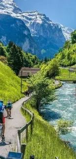 Mountain biking path with river and snow-capped mountains in a scenic landscape.