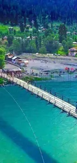 Scenic bridge over turquoise river with mountain backdrop.