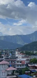 Mountain and city landscape under blue sky, perfect for wallpaper.