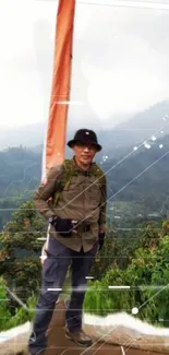 Person hiking on a mountain with lush green scenery, carrying a flag.