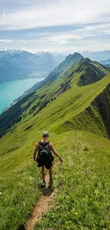 Man hiking on a scenic mountain trail with lake view.