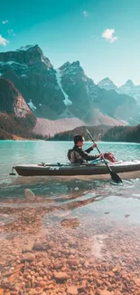 Kayaker on turquoise lake with mountain backdrop.