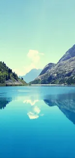 Serene mountain lake with sky reflection.