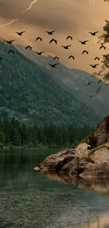 Tranquil mountain lake at sunset with flying birds and lush greenery.