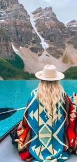 Woman canoeing on blue lake with mountain view.