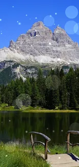 Serene mountain lake with a wooden footbridge under a clear blue sky.