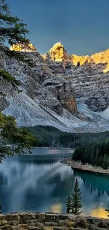 Serene mountain lake with clear water, forests, and sunlit peaks.