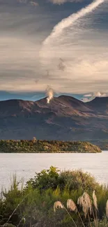 Serene mountain landscape with tranquil lake and cloudy sky